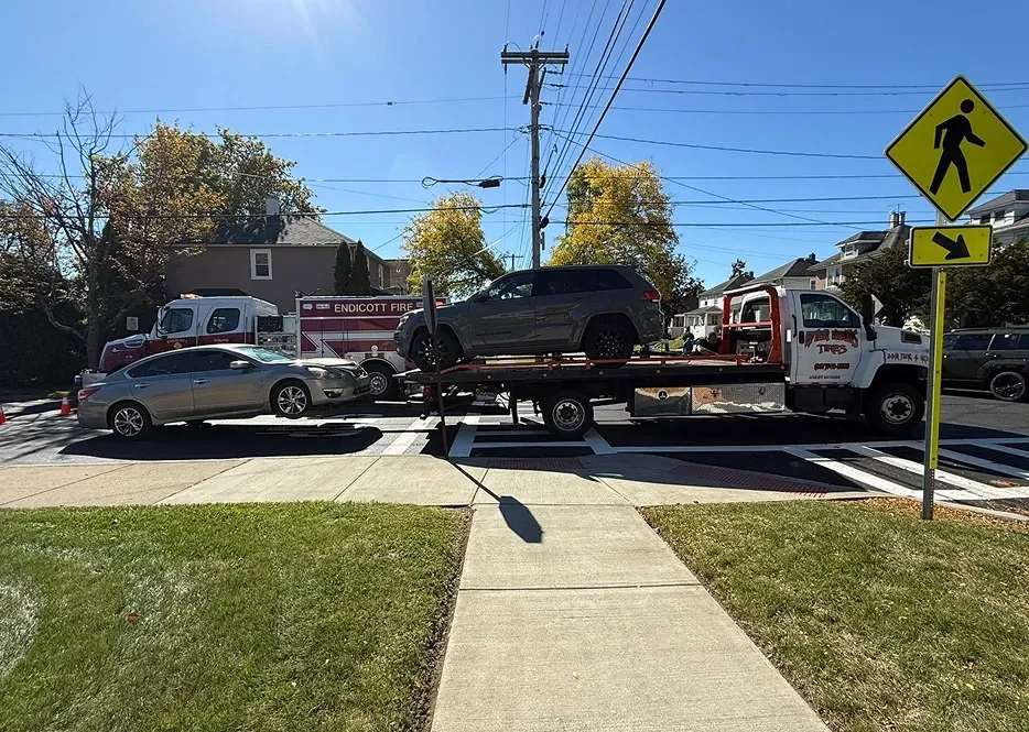 Towing in progress, two cars being towed by our expert towing truck team | After Hours Tires