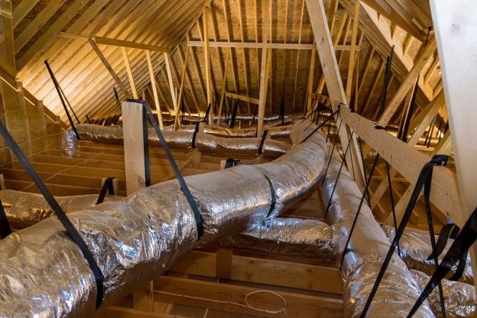 There are a lot of ducts in the attic of a house under construction.