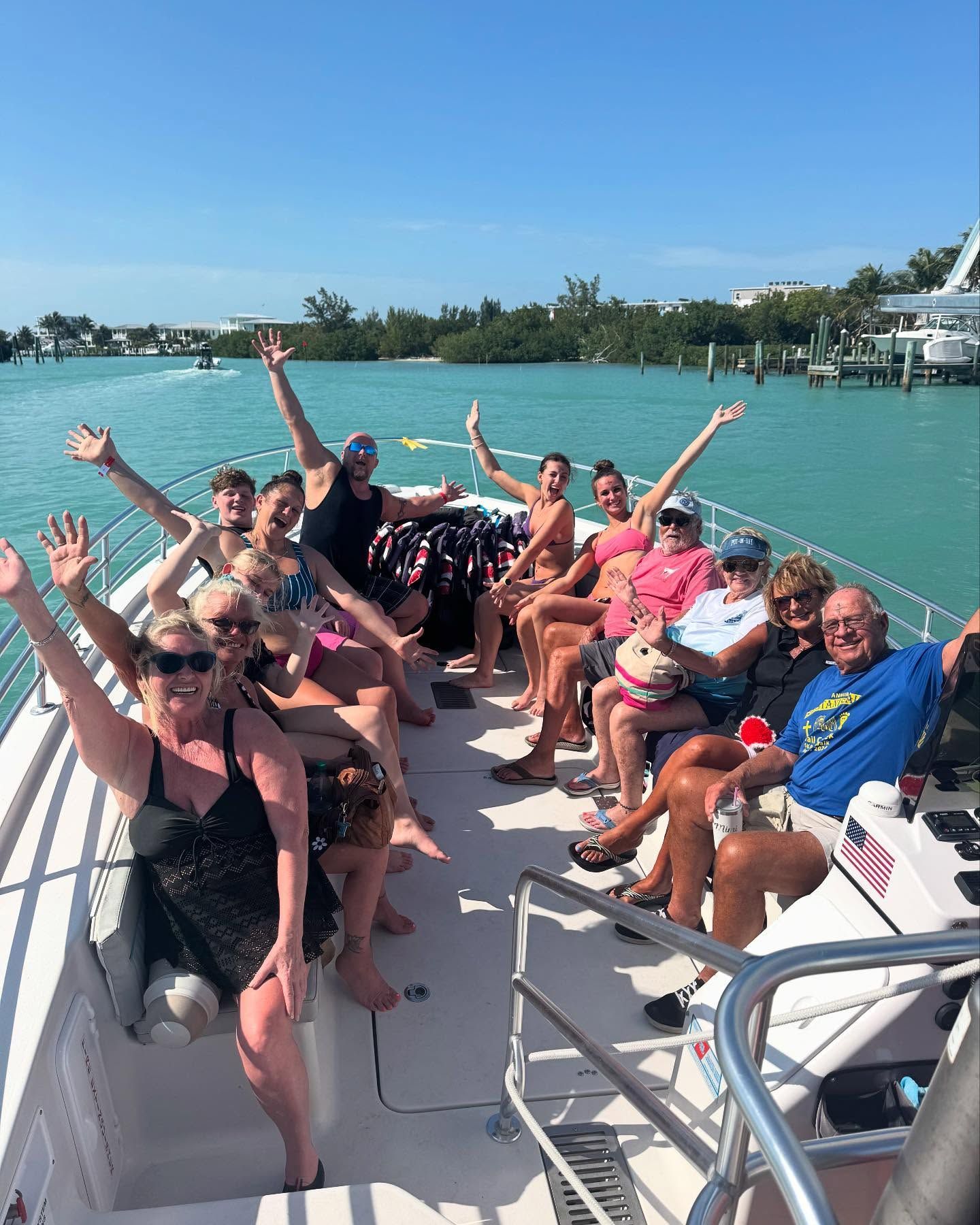 A group of people are sitting on a boat in the water.