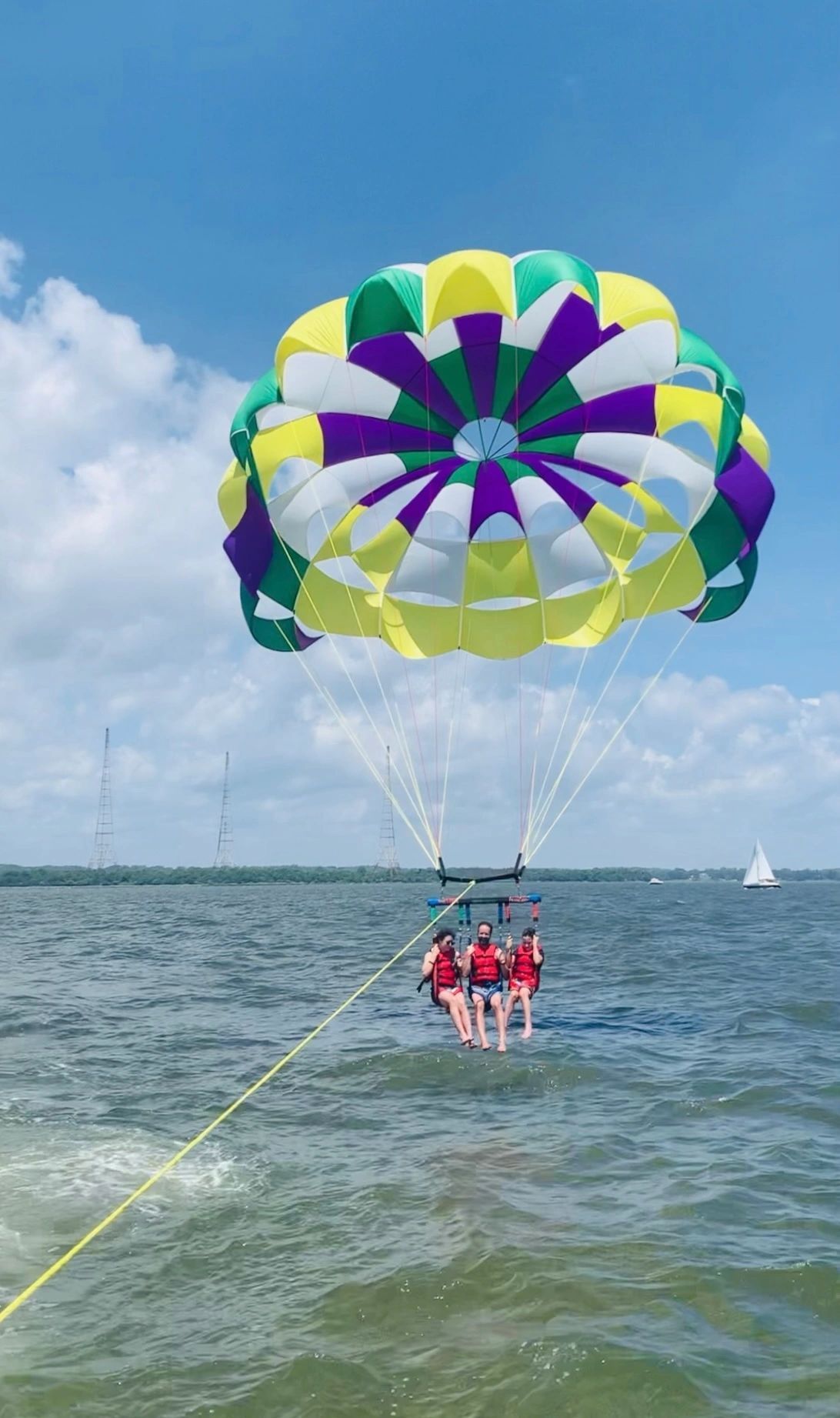 A group of people are parasailing over the ocean.