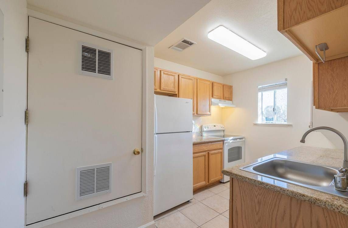 Photo showing a kitchen with plenty of lighting