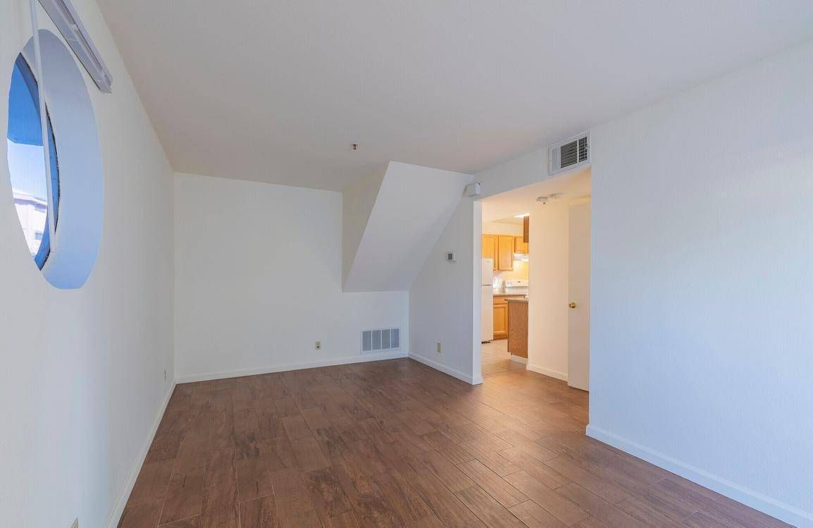 Photo showing a living room with a unique, circular window
