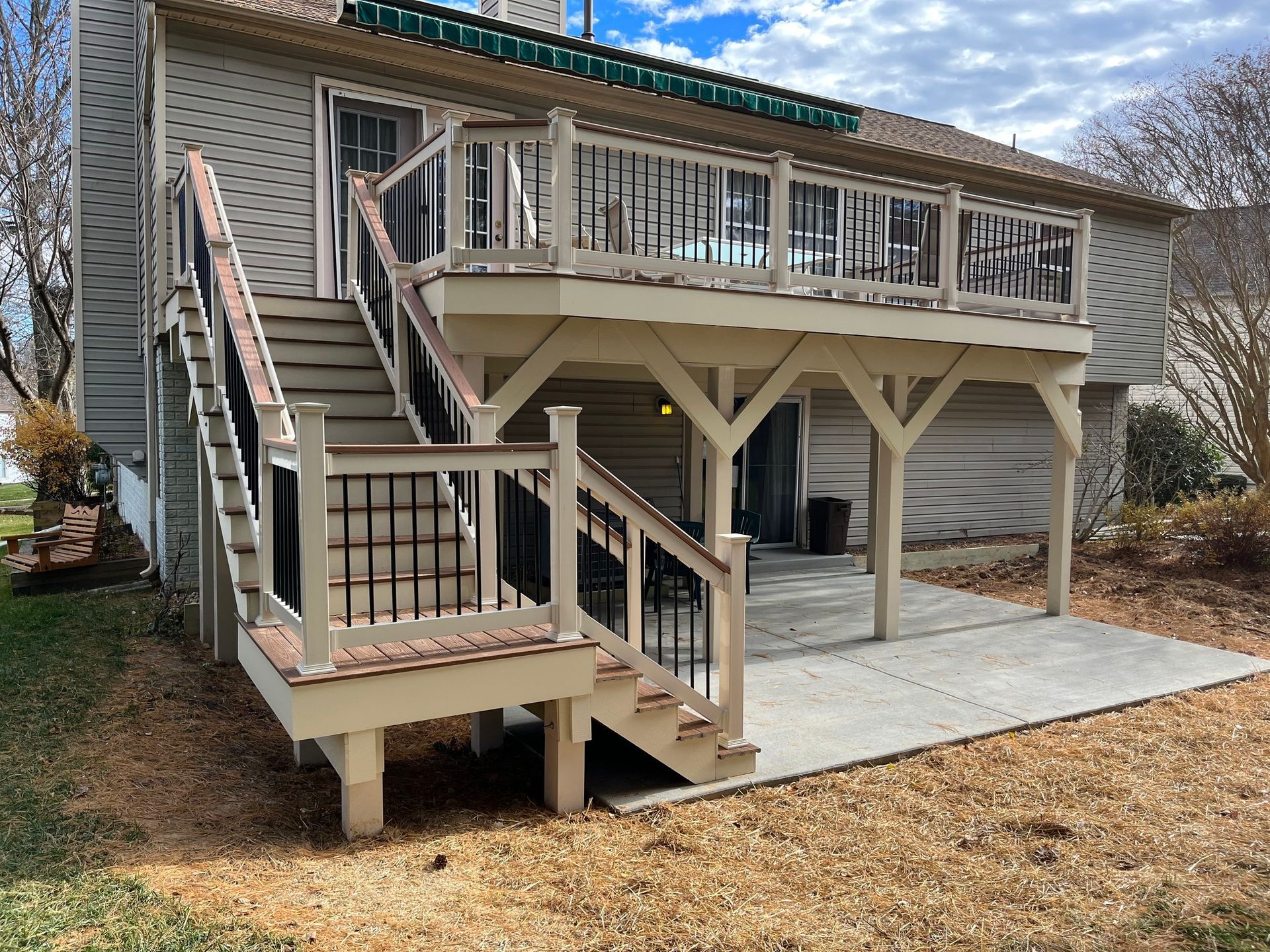 A house with a large deck and stairs leading up to it.