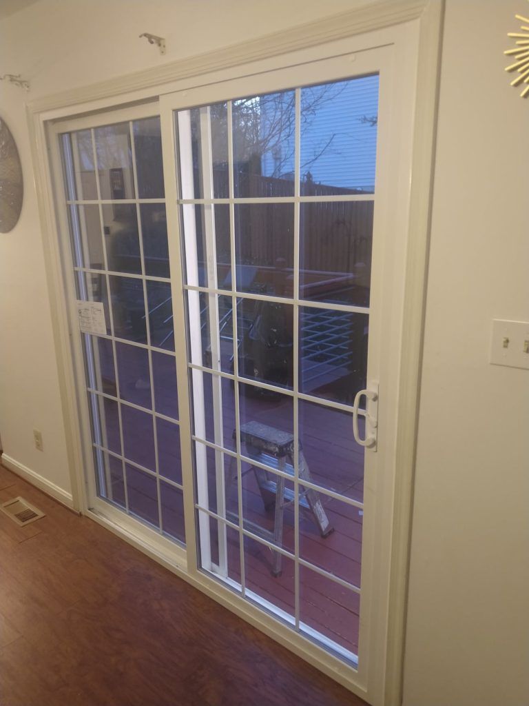 A living room with a sliding glass door leading to a patio.