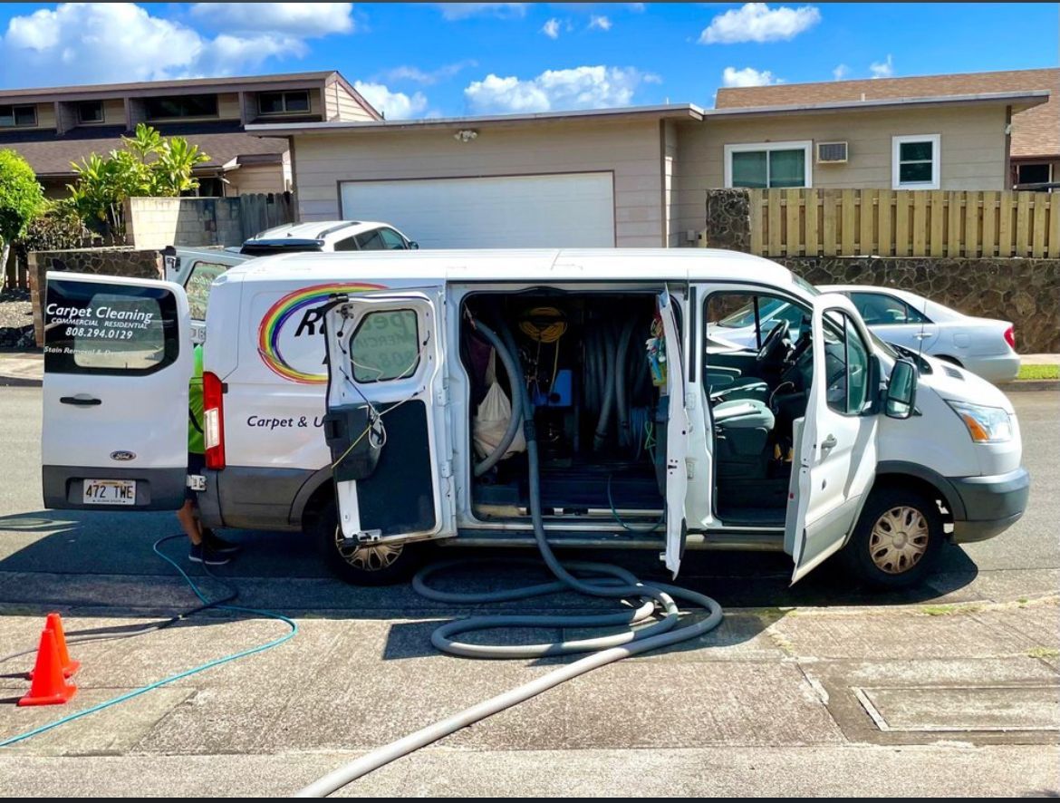 A white van is parked in a parking lot with its doors open.
