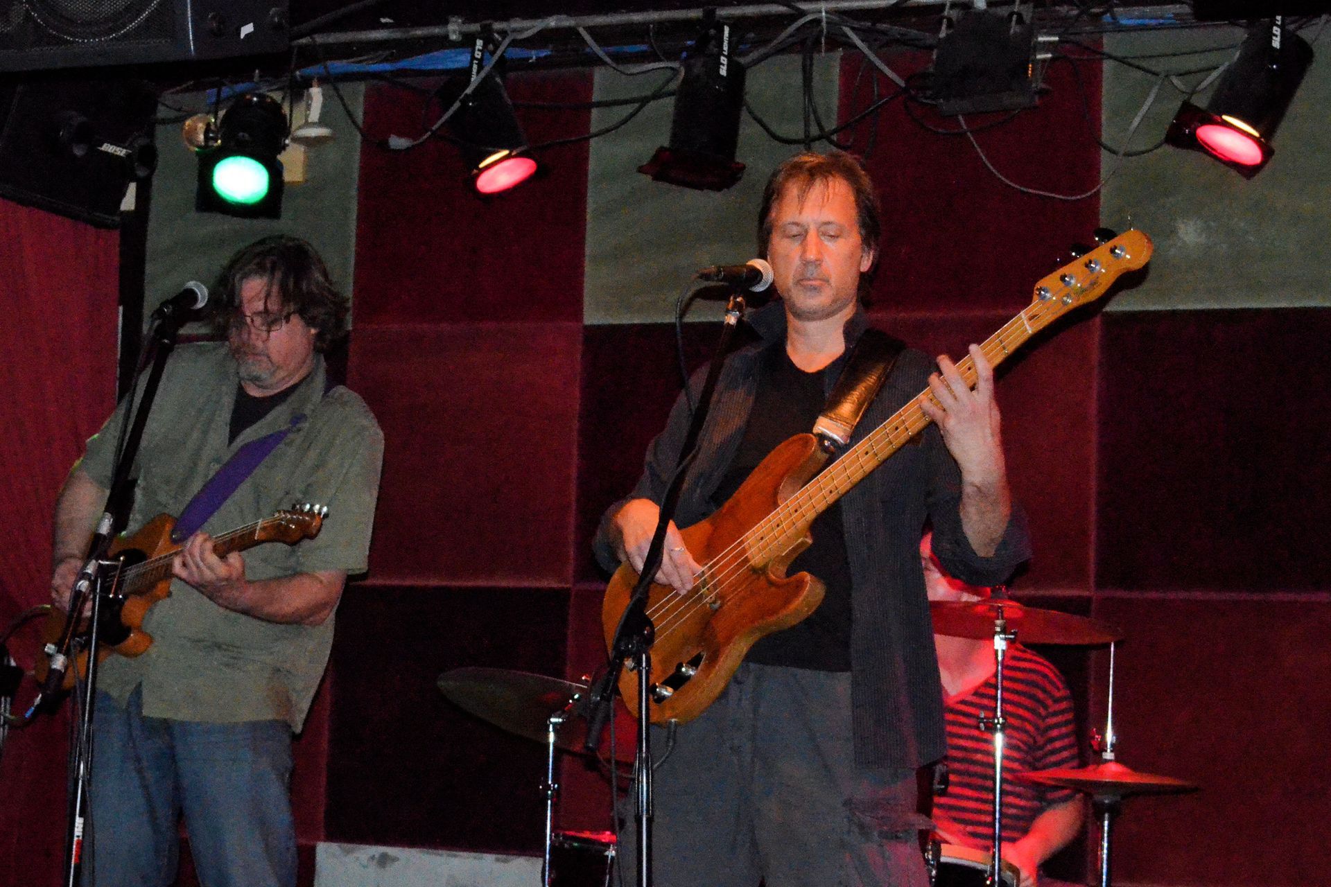 Matt Feinberg playing guitar in front of a microphone