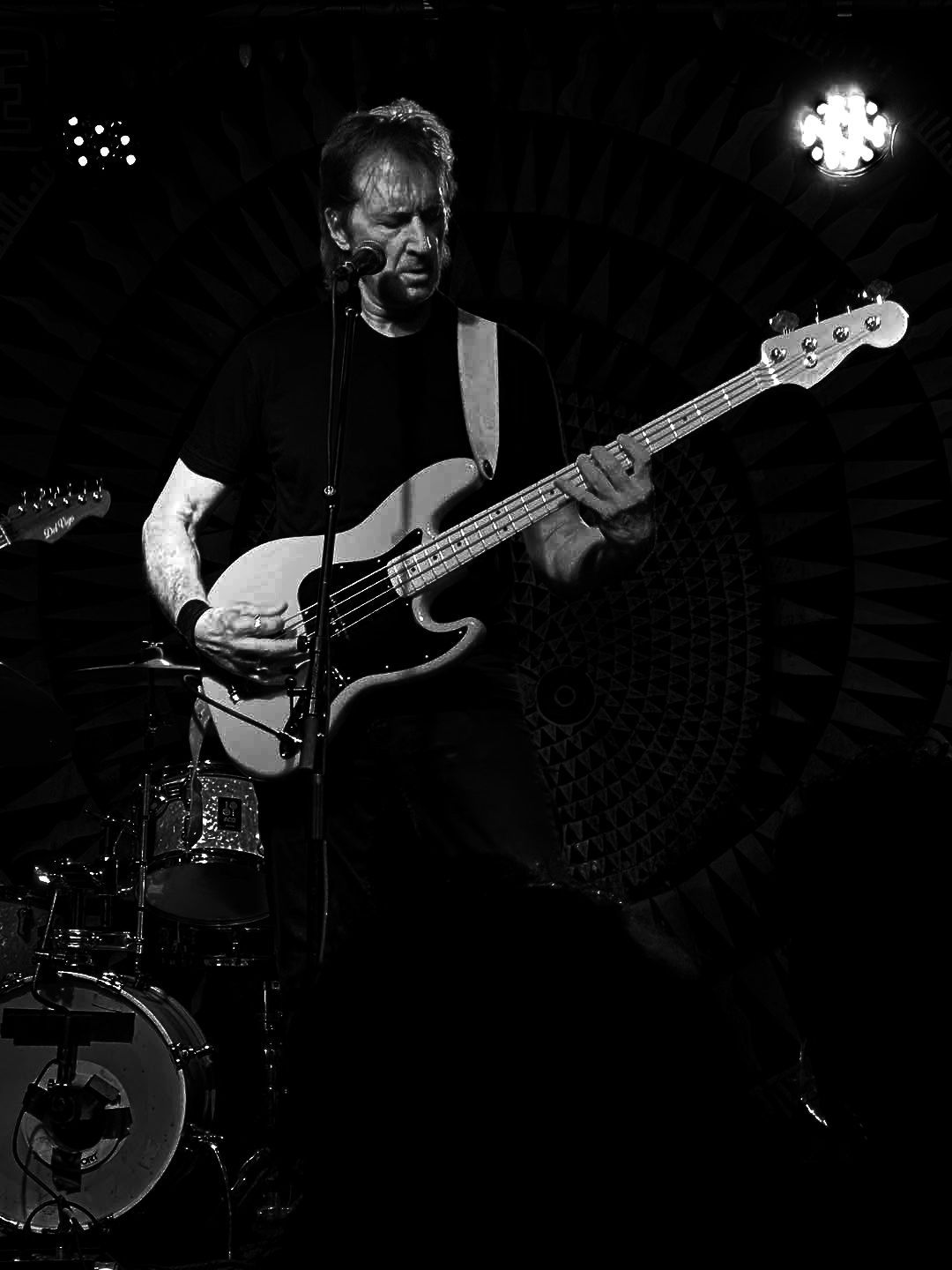 Matt Feinberg playing guitar with a checkered pattern