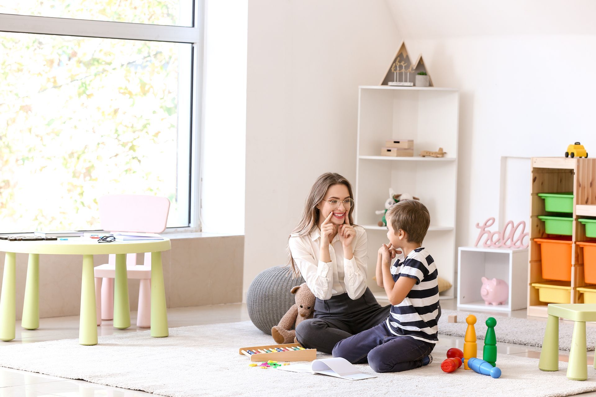 Family smiling and talking on a couch in a well-lit living room.