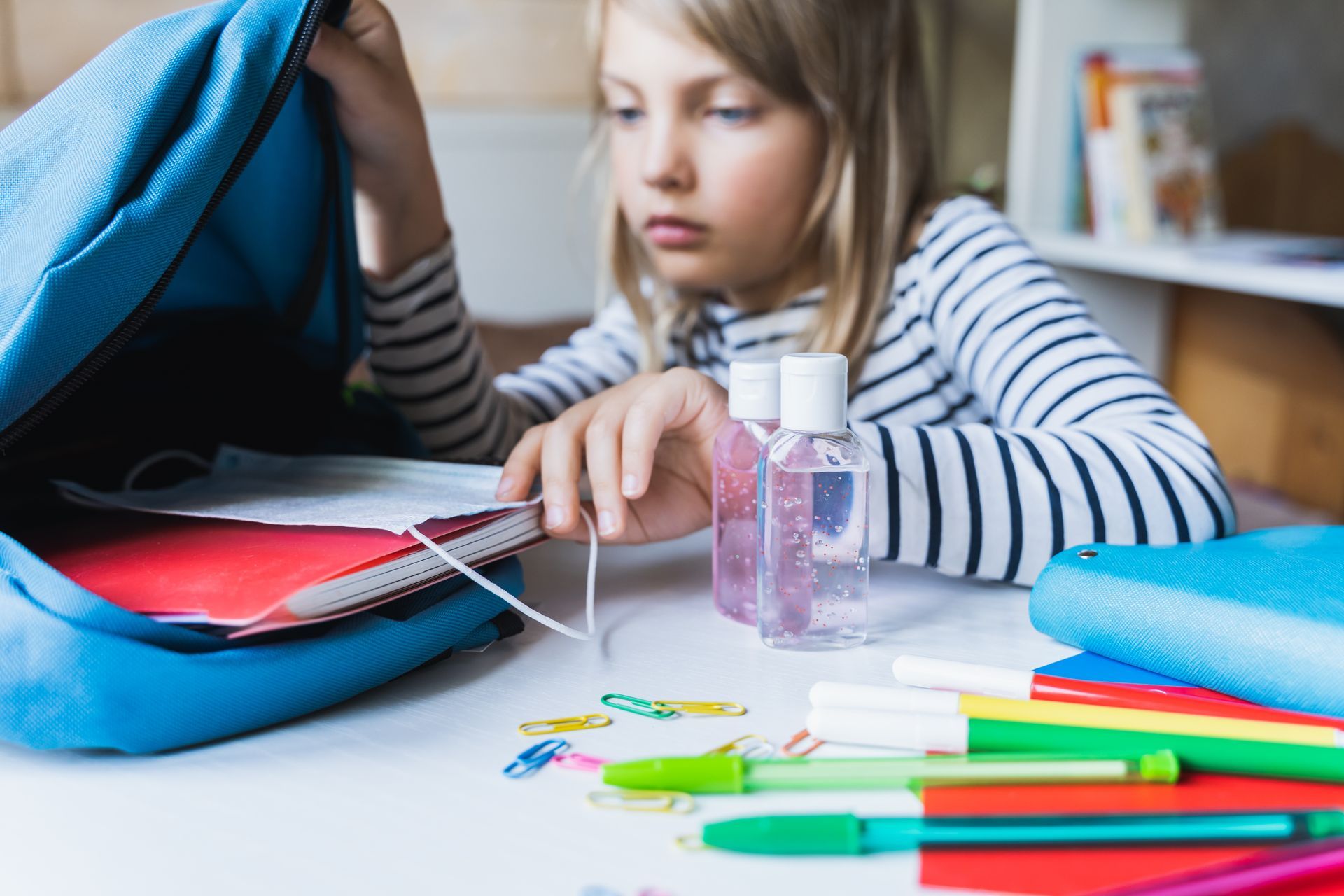 Family smiling and talking on a couch in a well-lit living room.