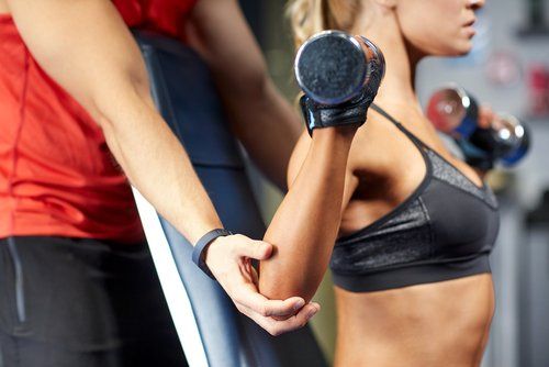 woman with a trainer at a gym