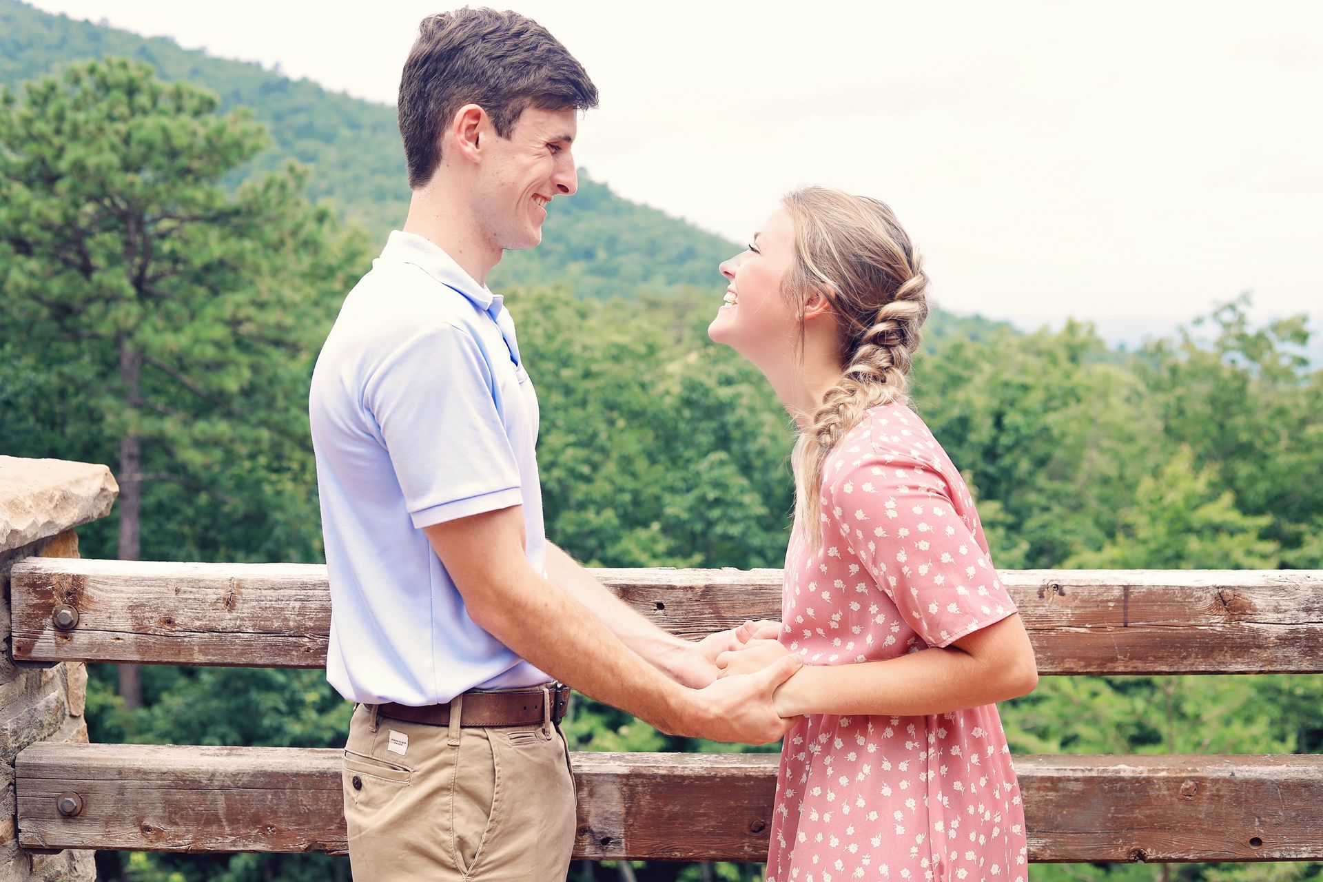 A man and a woman are holding hands and looking at each other.