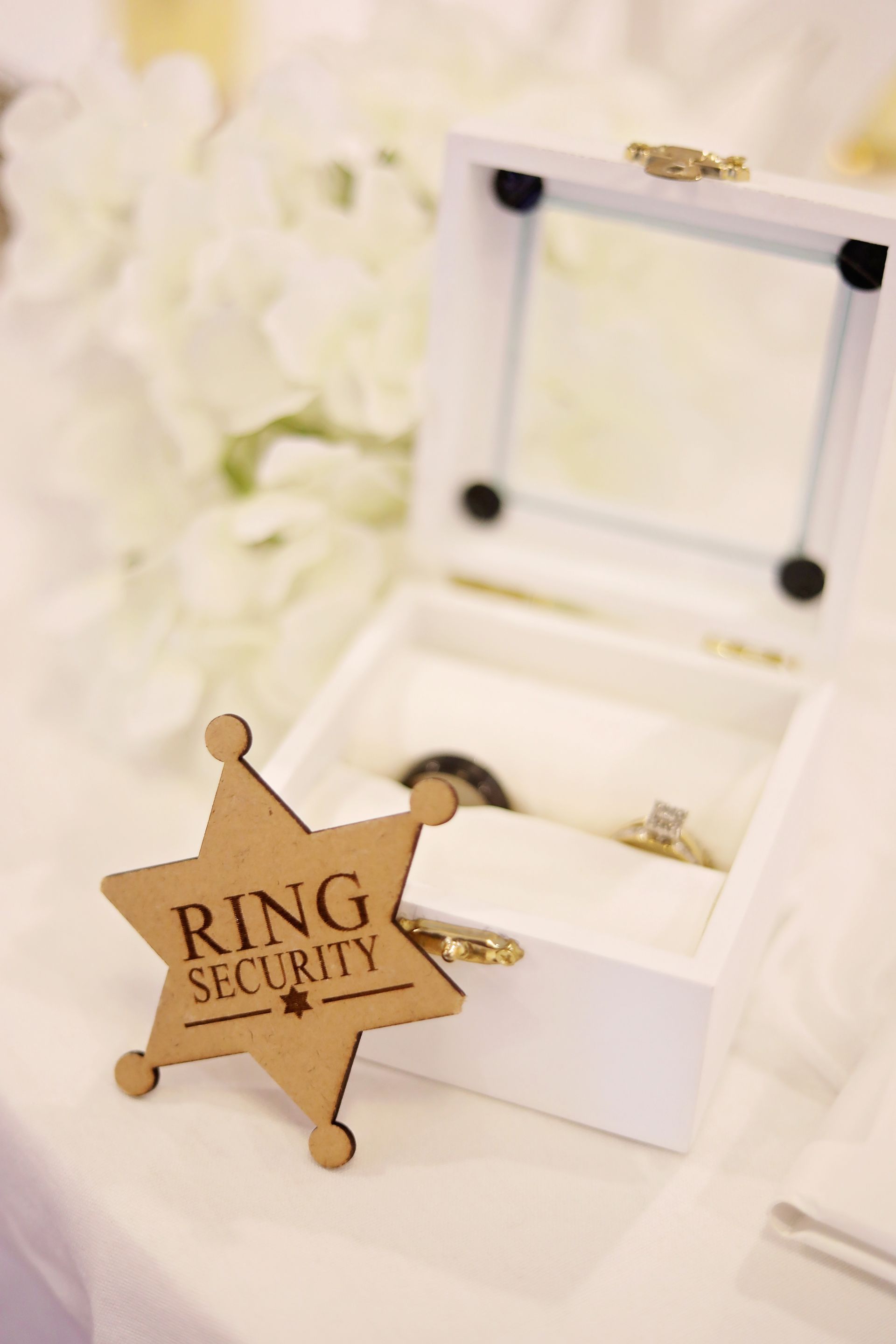 A wooden sheriff 's badge with the words ring security on it