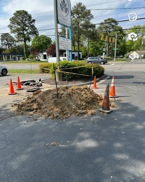 A large pile of dirt is on the side of the road