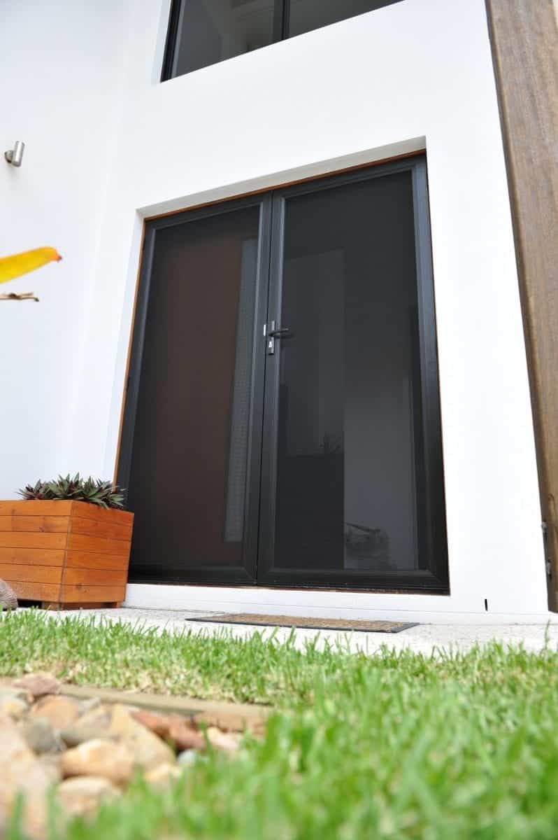 A House With A Sliding Glass Door And A Planter In Front Of It — North Ballina Windows In Byron Bay, NSW