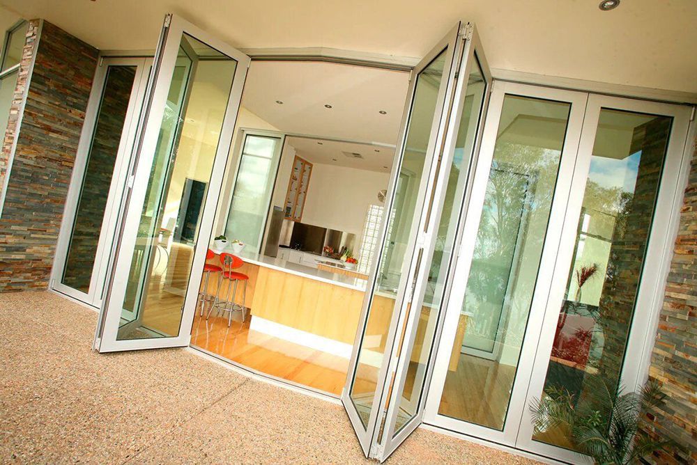 A House With A Lot Of Glass Doors Leading To A Kitchen — North Ballina Windows In Yamba, NSW