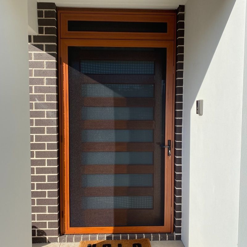 A Door With A Screen And A Welcome Mat In Front Of It — North Ballina Windows In Ballina, NSW