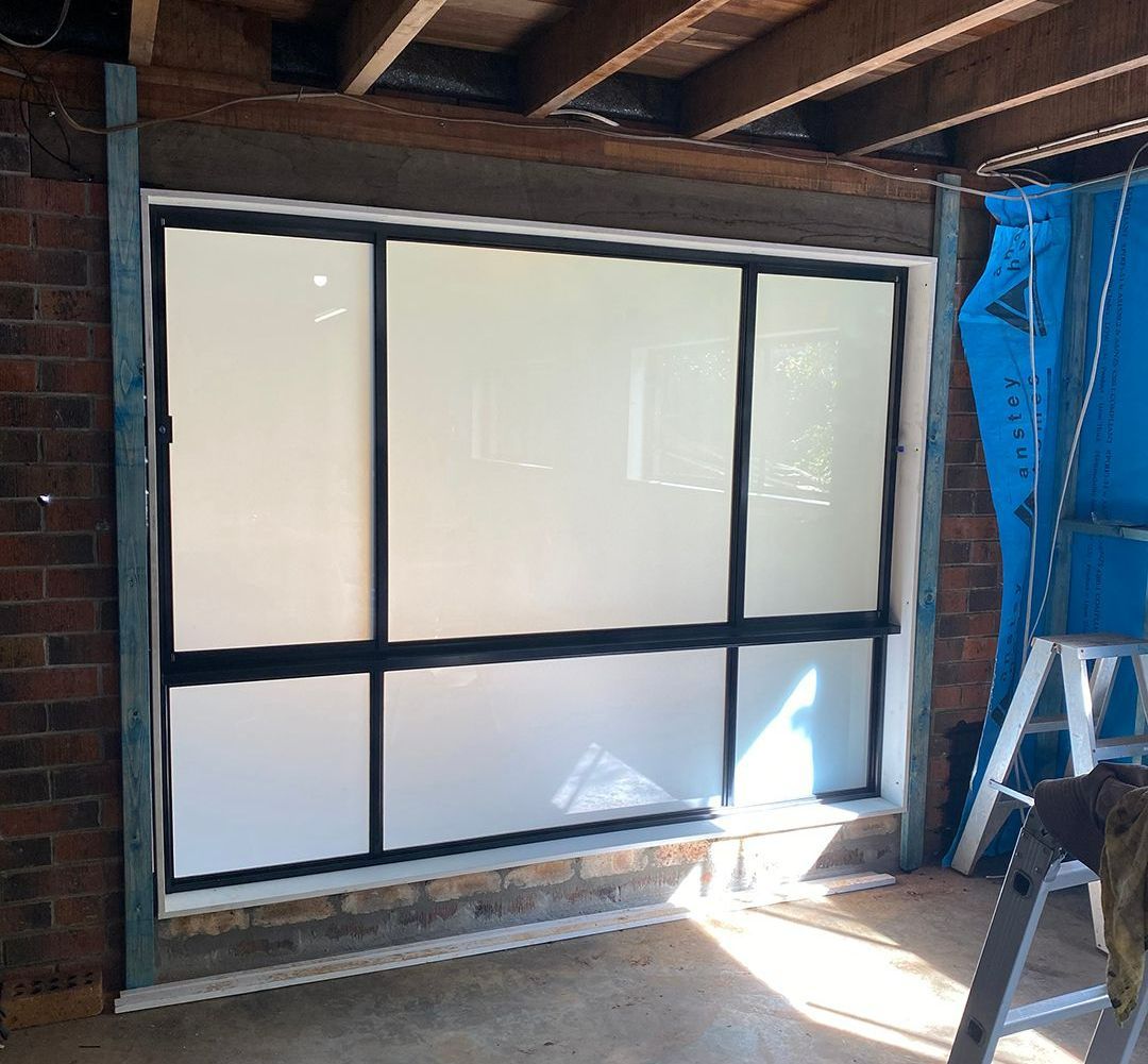 A Large Frosted Window Is Being Installed In A Room - North Ballina Windows In Lismore, NSW