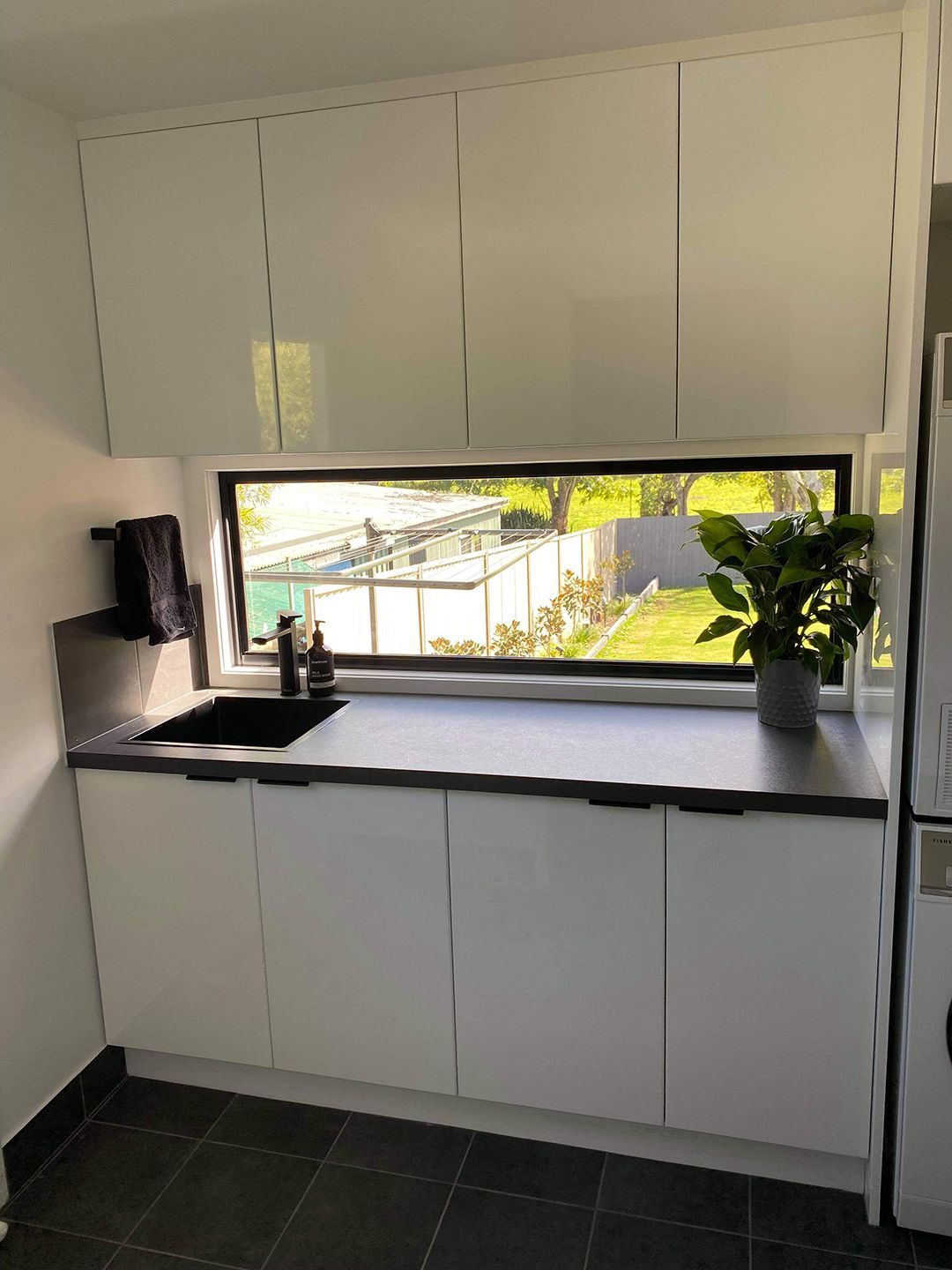 A Kitchen With White Cabinets  A Sink, And A Window — North Ballina Windows In Casino, NSW