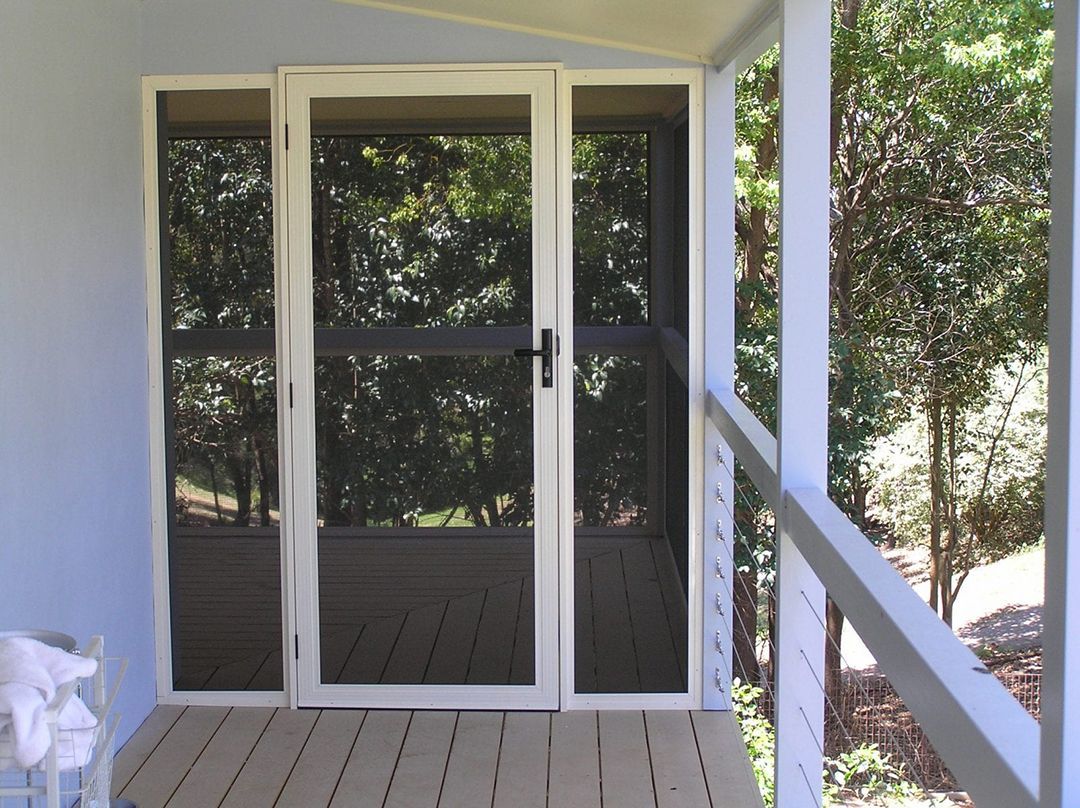 A Screened In Porch With Trees In The Background — North Ballina Windows In Ballina, NSW
