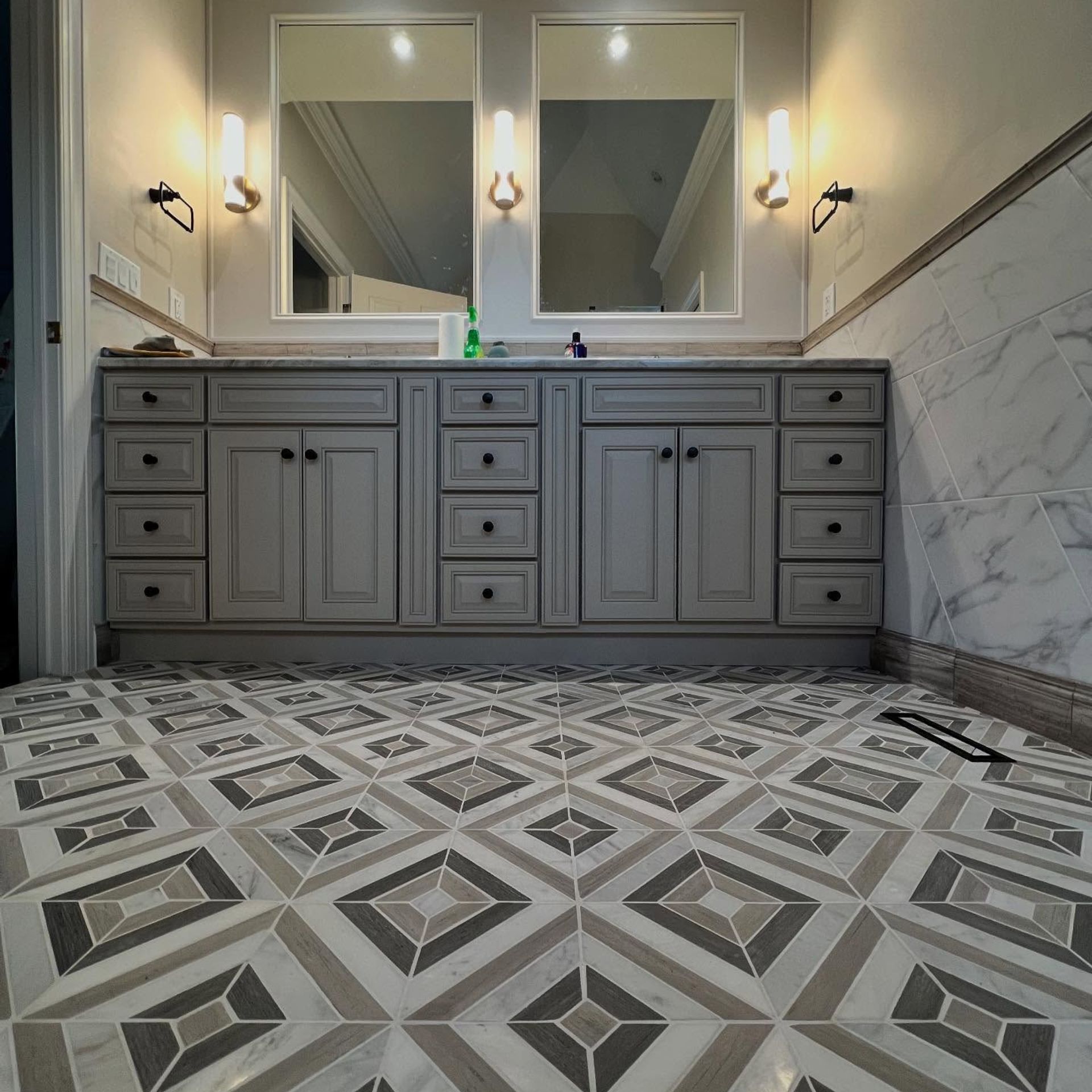 WCL Construction/Paint & Carpentry Inc - A bathroom with two sinks , two mirrors and a tiled floor.