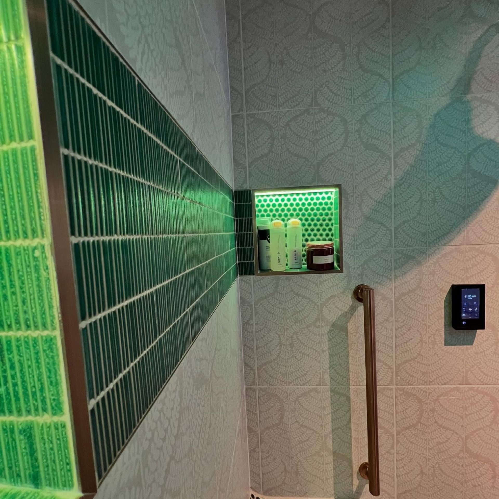 WCL Construction/Paint & Carpentry Inc - A bathroom with green tiles and a hand rail