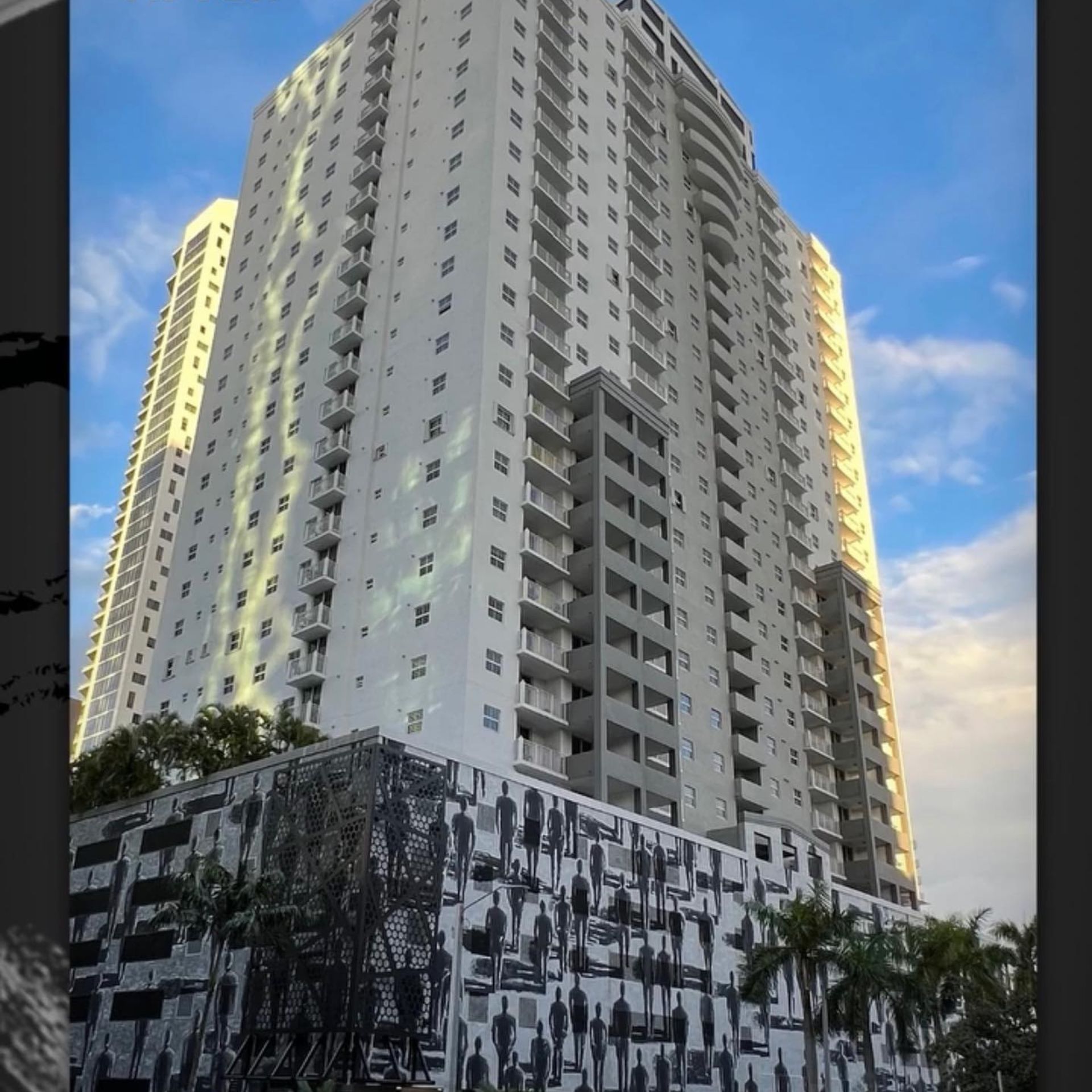 WCL ConstructionPaint Carpentry Inc - A tall building with a lot of windows and balconies
