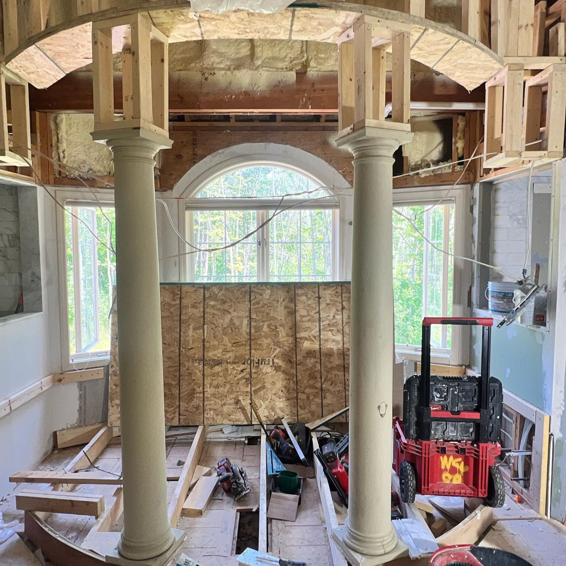 WCL ConstructionPaint Carpentry Inc - A room with columns and a red truck that says mq on it