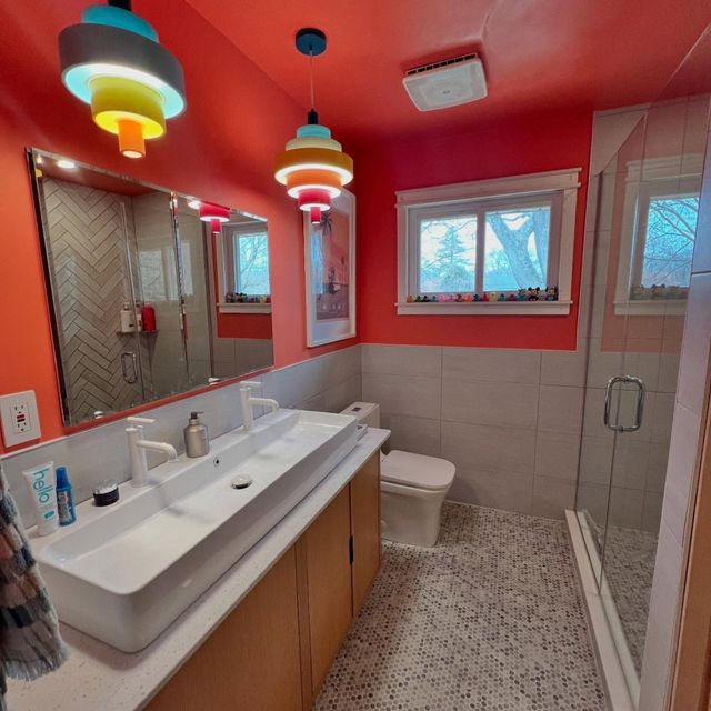 WCL ConstructionPaint Carpentry Inc - A bathroom with red walls and a sink and toilet