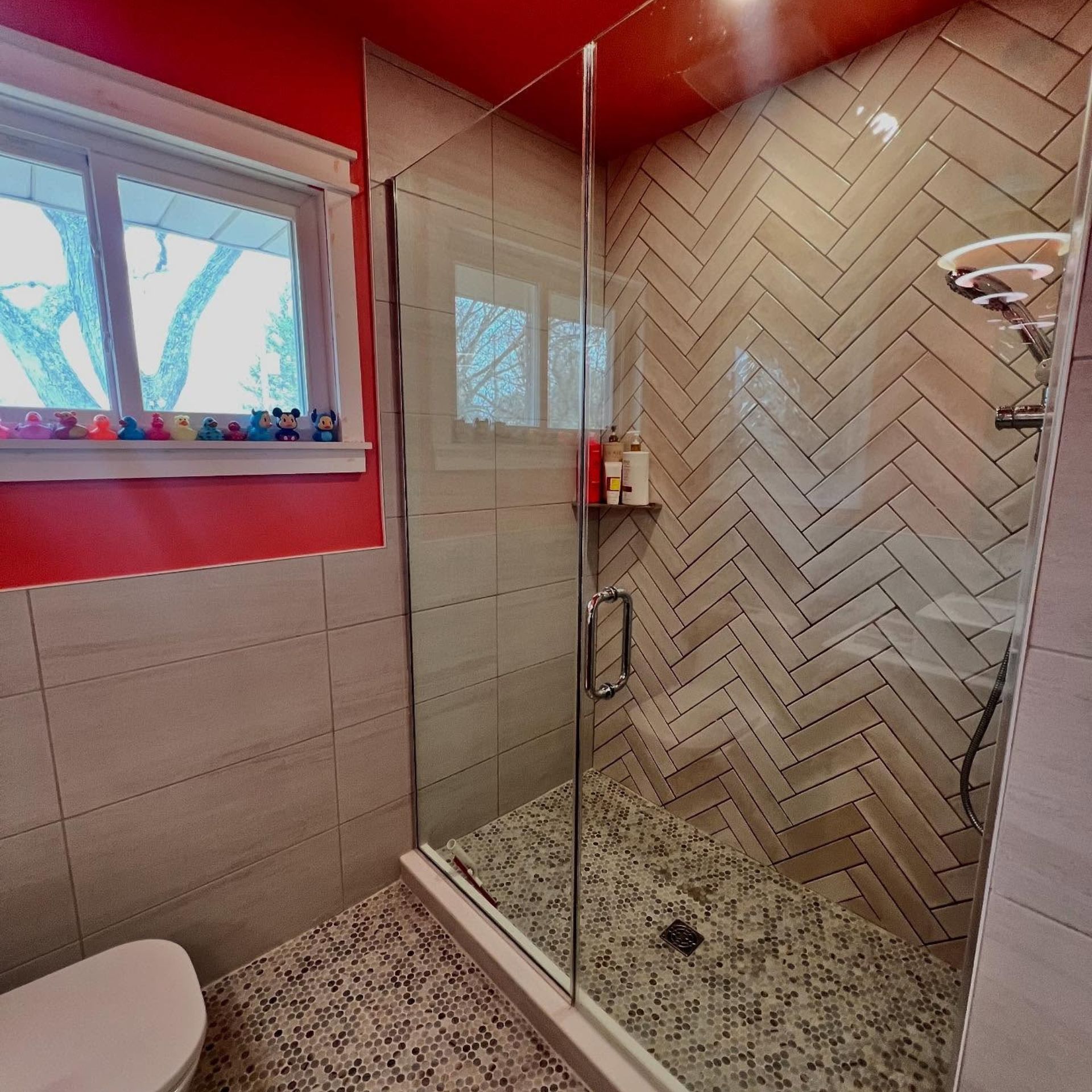 WCL Construction/Paint & Carpentry Inc  - A bathroom with a walk in shower and a toilet