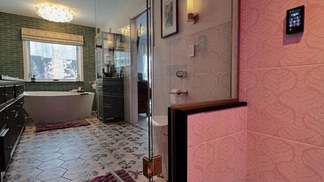 WCL ConstructionPaint Carpentry Inc - A bathroom with a bathtub and a walk in shower.