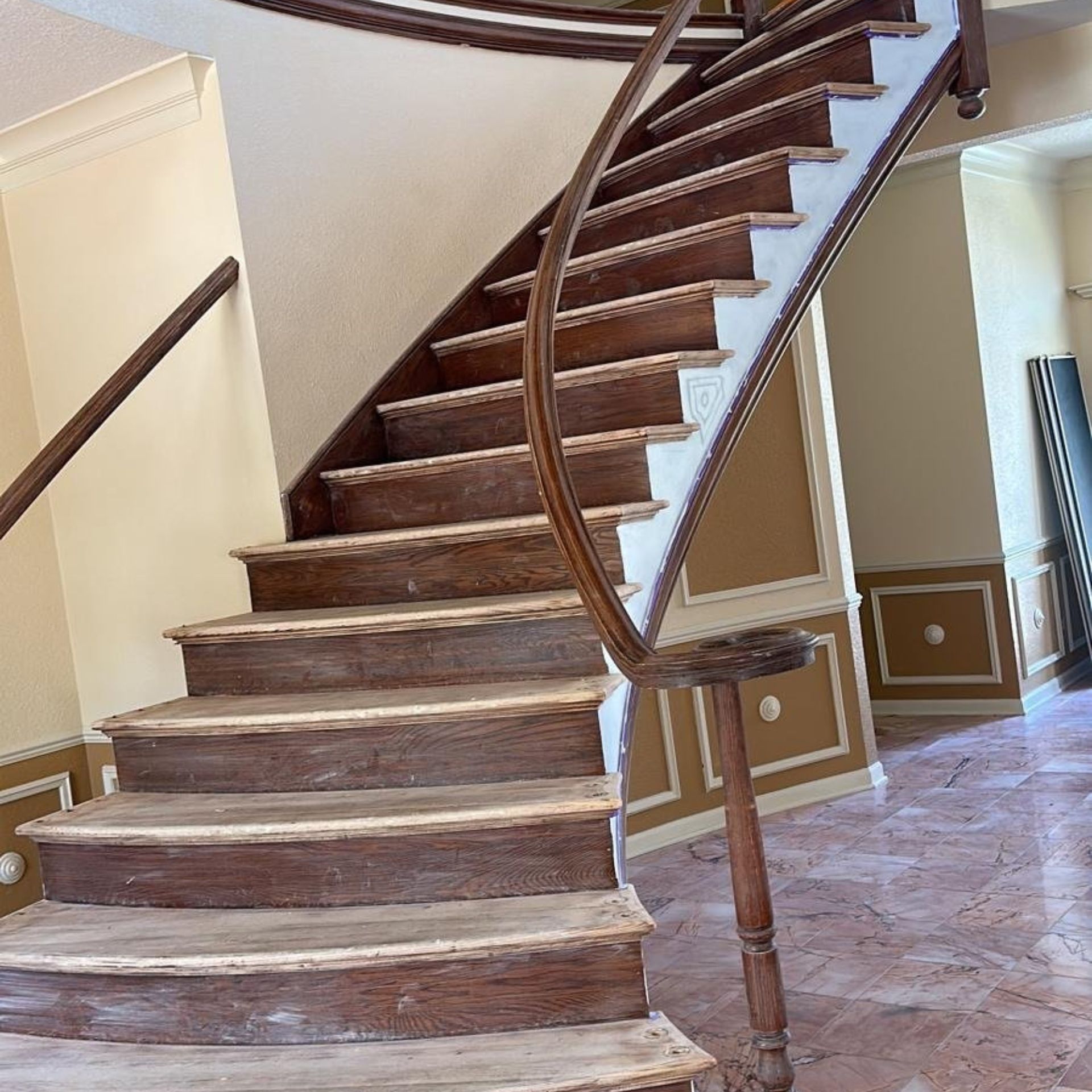 WCL Construction/Paint & Carpentry Inc - A wooden staircase with white steps and a wooden railing