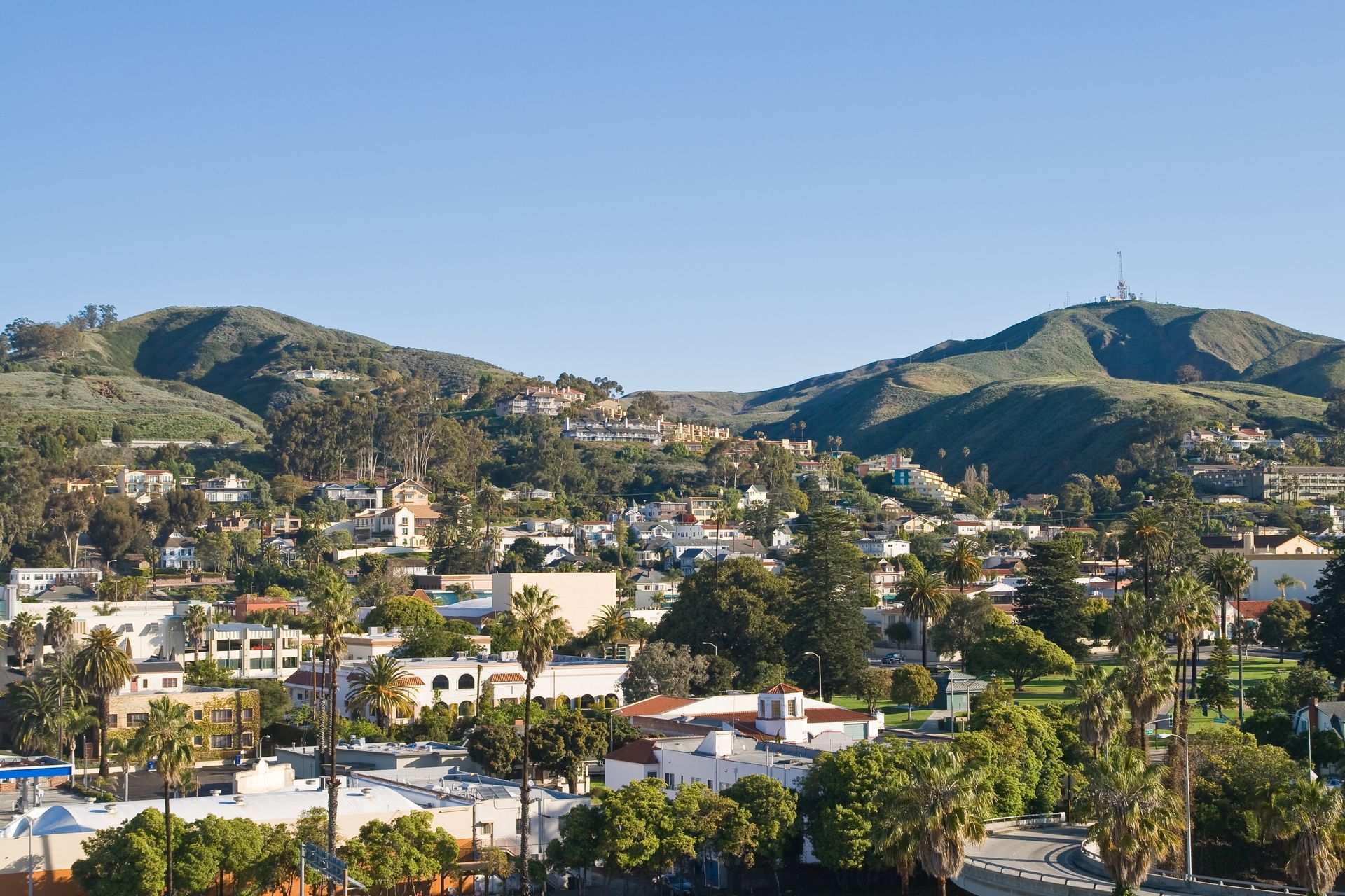 An aerial view of a city with mountains in the background