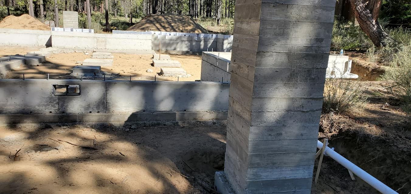 Construction site with concrete foundation and column.