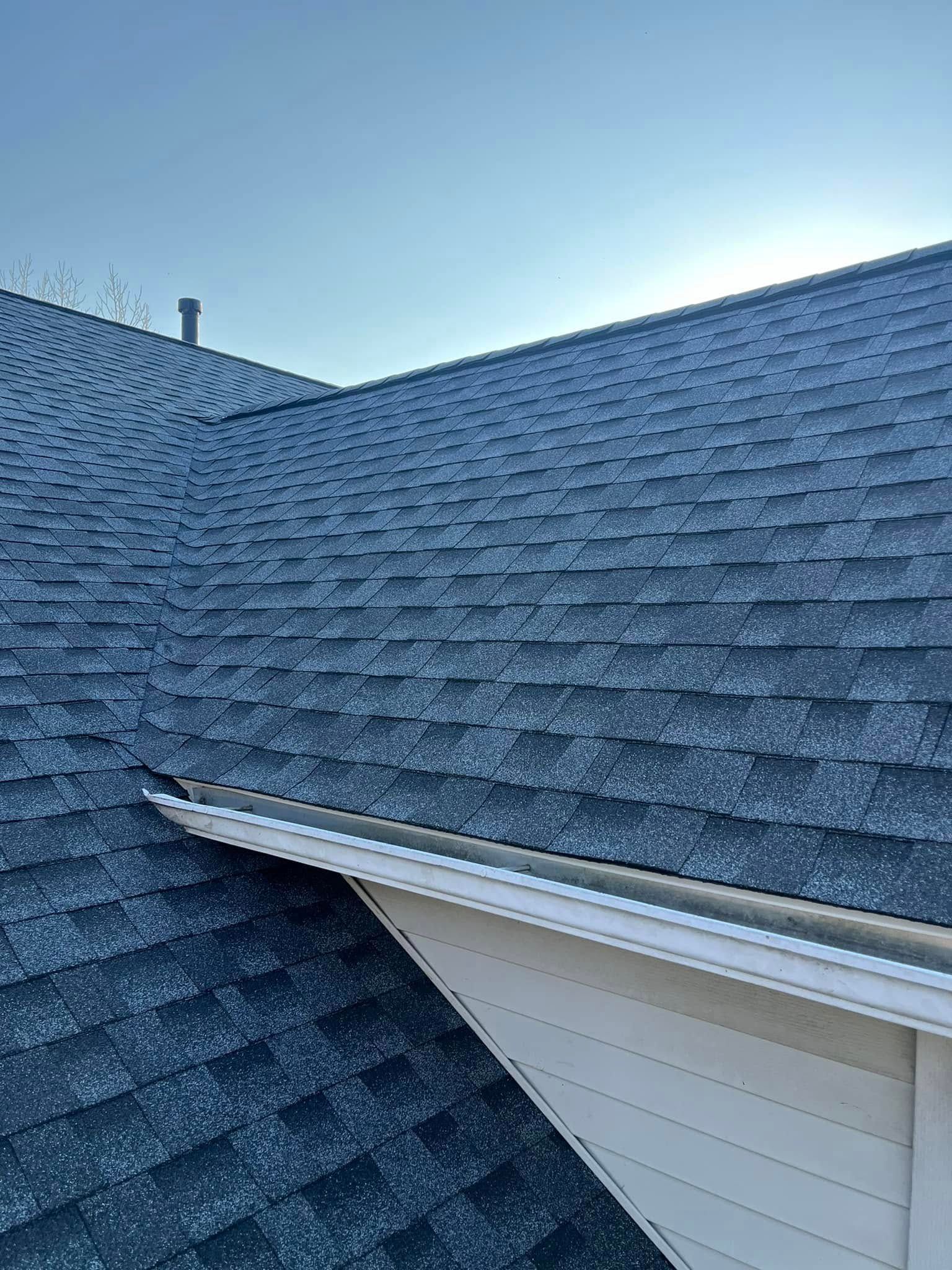 A close up of a roof with a blue sky in the background.