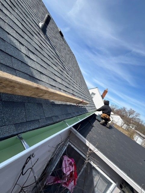 A close up of a gutter on the side of a house.
