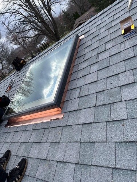 A man is cleaning the roof of a house