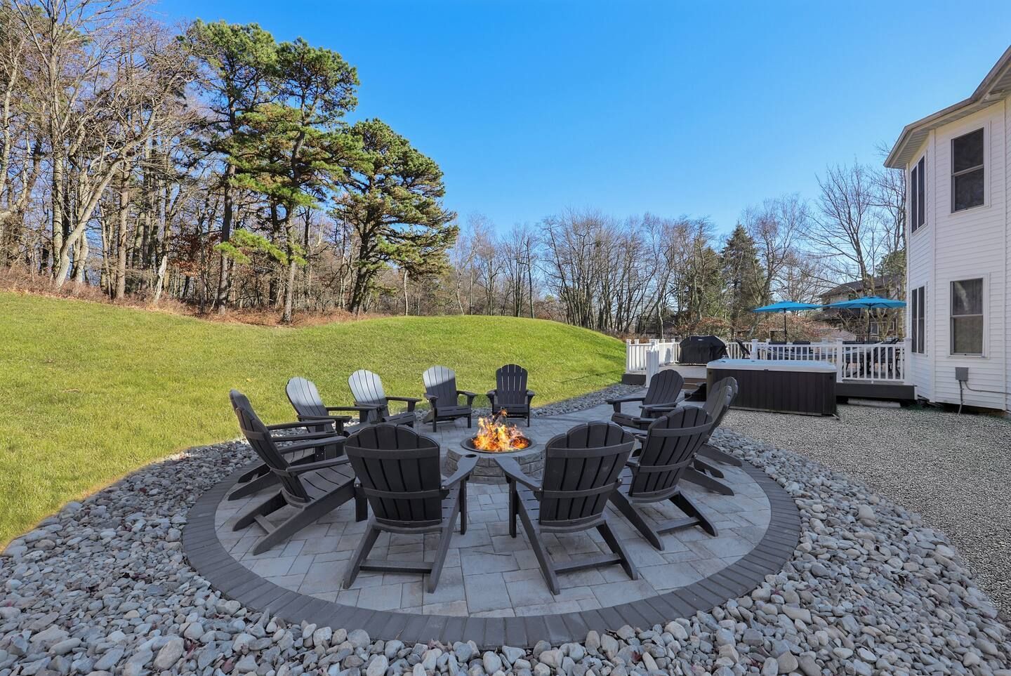 Back patio with a fire pit and a hot tub