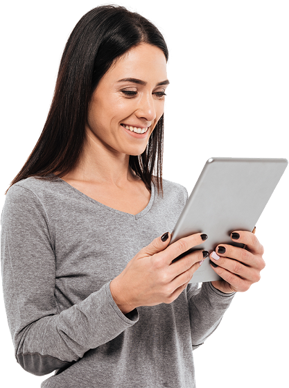 Woman with dark hair smiles while using a tablet, wearing a gray shirt.