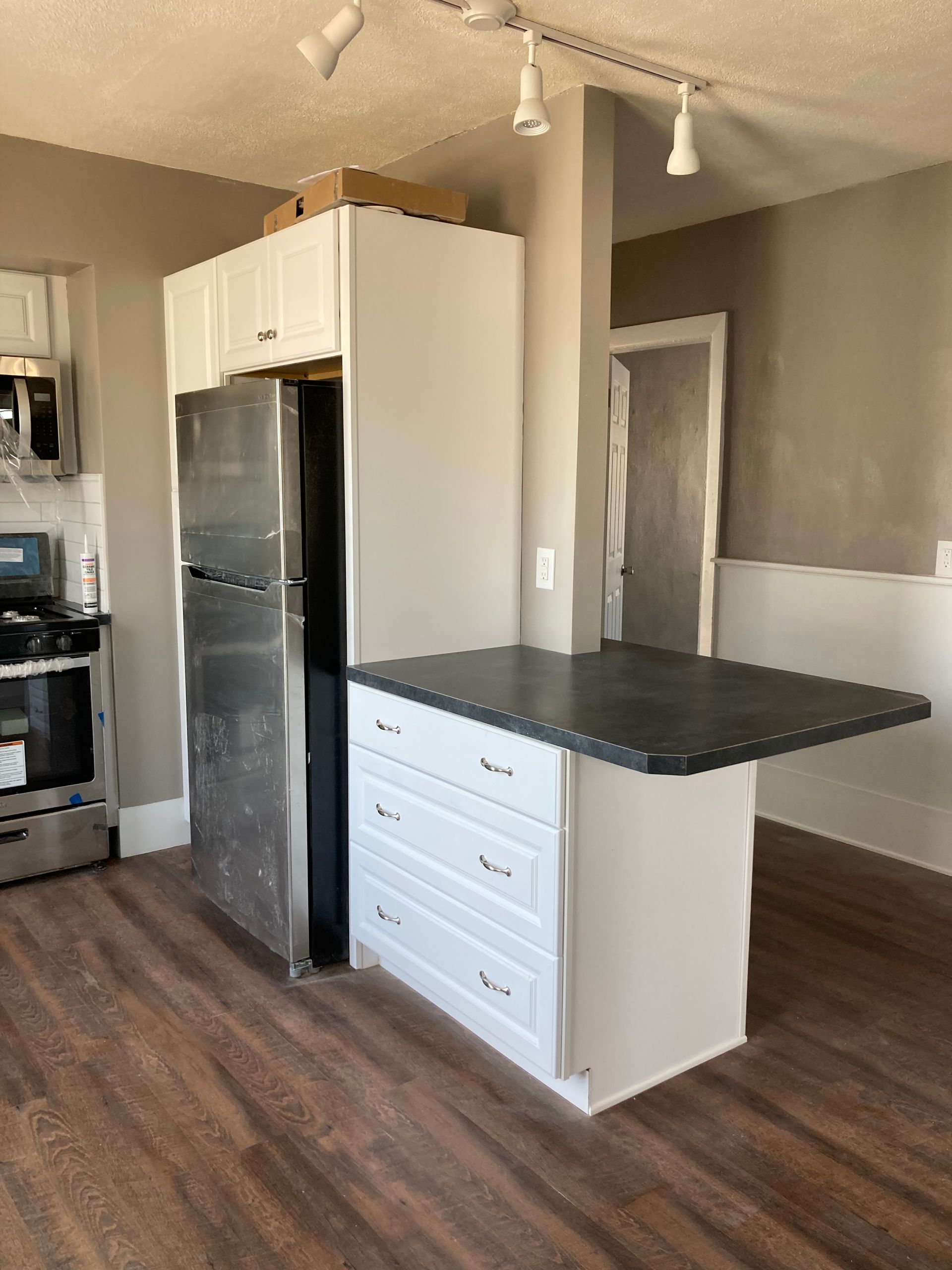 finished kitchen with island attached to fridge