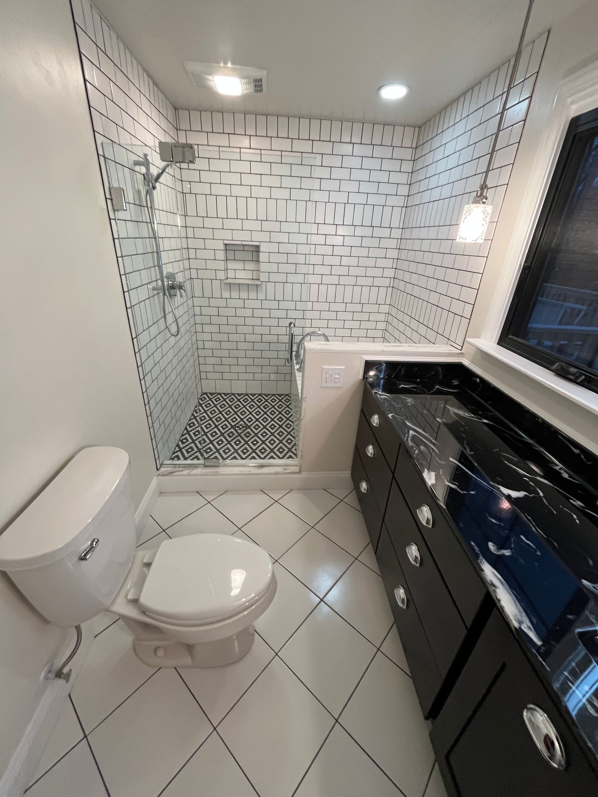 A bathroom with a toilet and a walk in shower