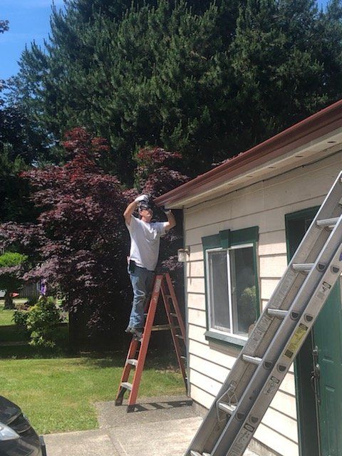 Worker Installing a Gutter — Bremerton, WA — Novak’s Gutters