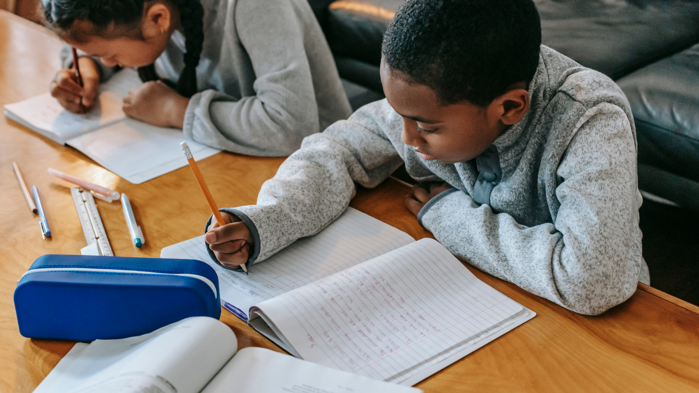 Girl with pigtails holds a card with the letter