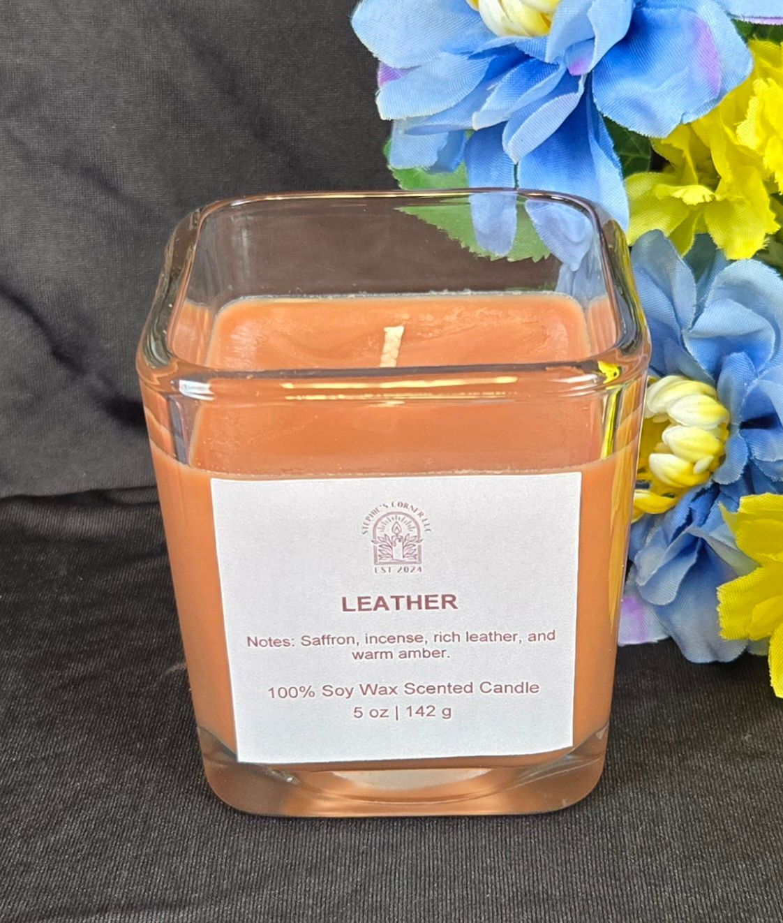 Leather scented 100% soy candle in a 5 ounce glass cube jar.