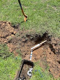 A person is digging a hole in the ground with a shovel.