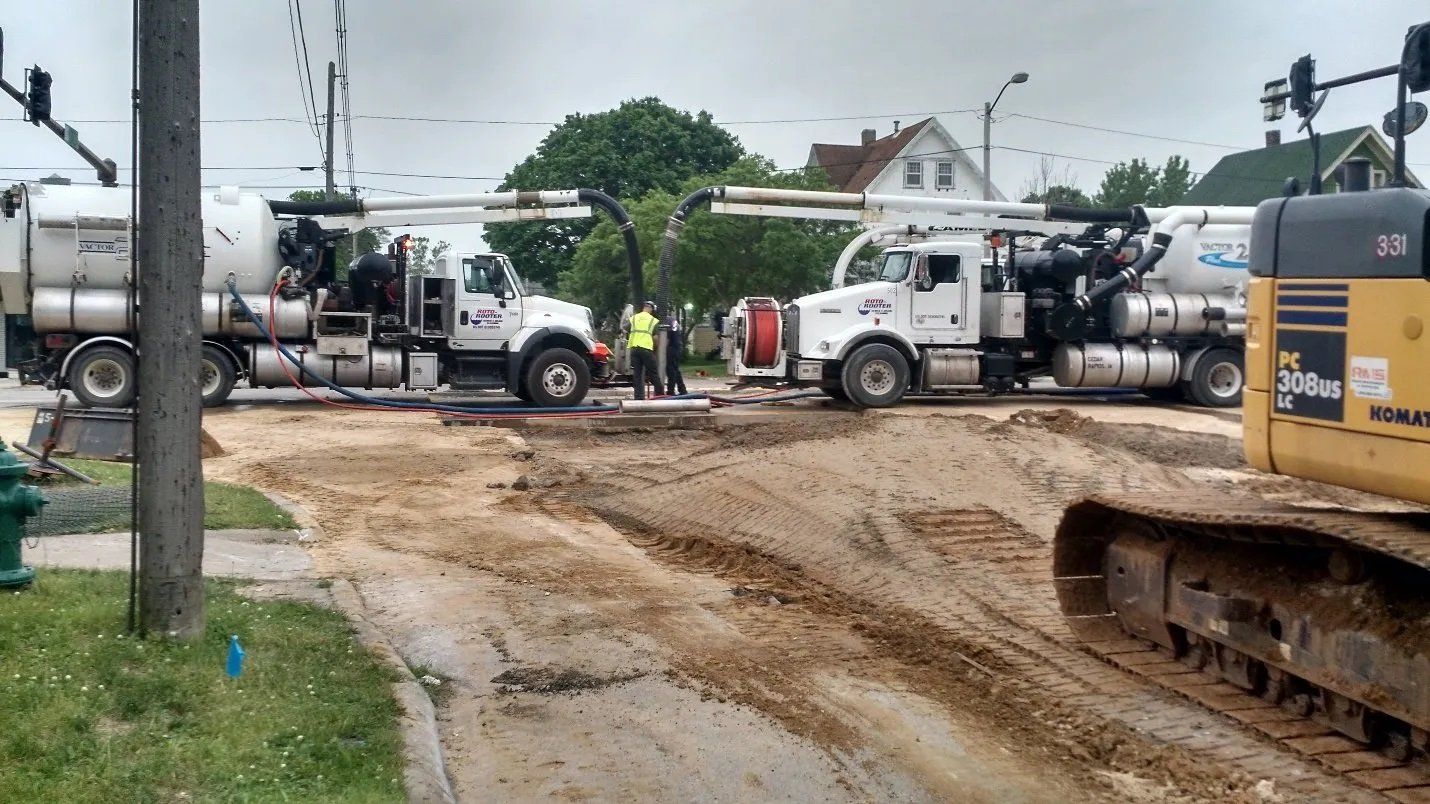 Work Trucks on Jobsite - Cedar Rapids, IA - Roto Rooter Sewer & Drain Cleaning