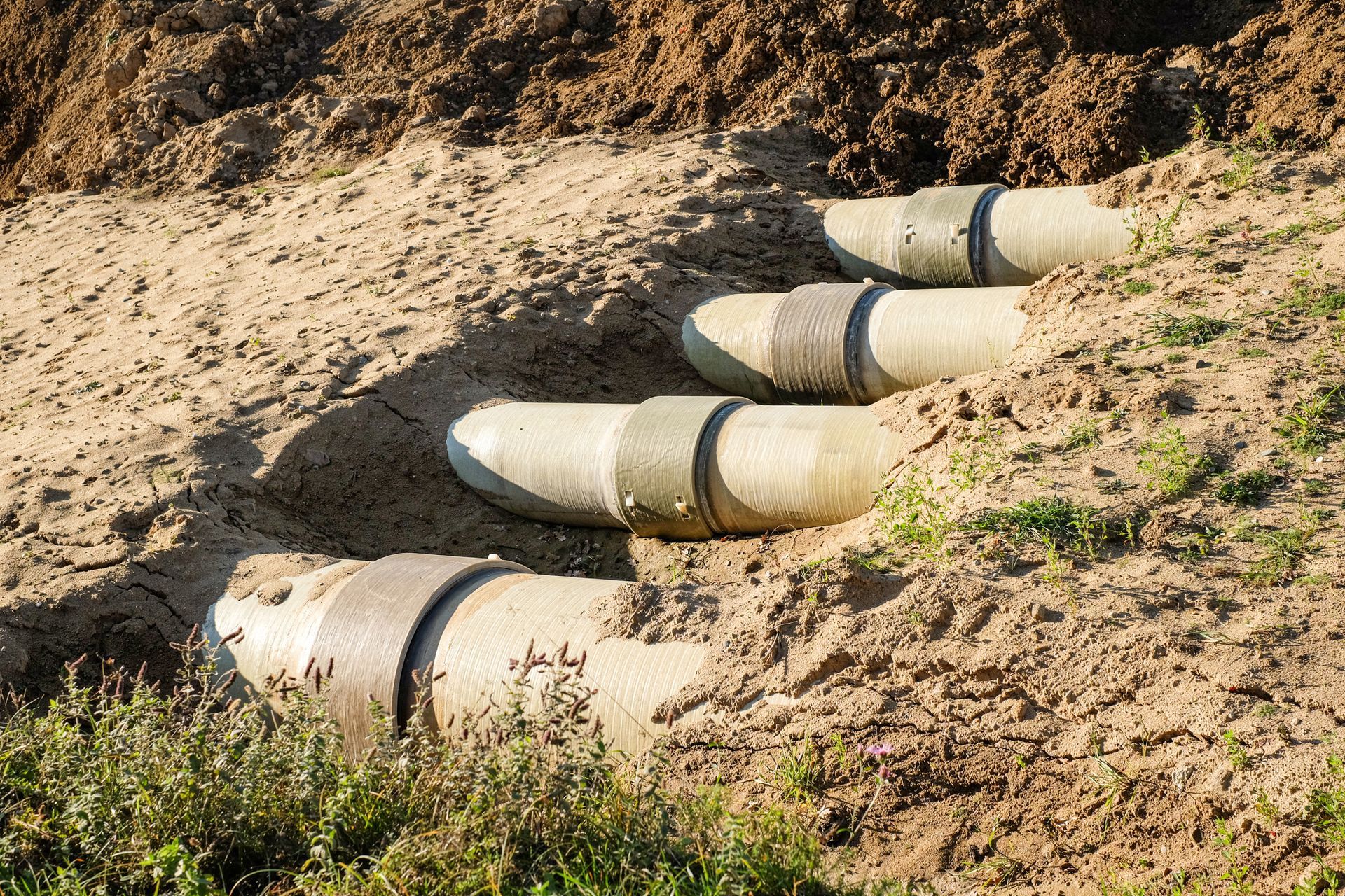 New fiber glass water pipeline in trench. New fiber glass water pipeline in trench.