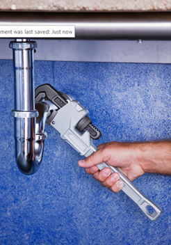 Man’s hand grips a pipe wrench against a blue wall backdrop, ready for drain cleaning in Marion, IA. Man’s hand grips a pipe wrench against a blue wall backdrop, ready for drain cleaning in Marion, IA.