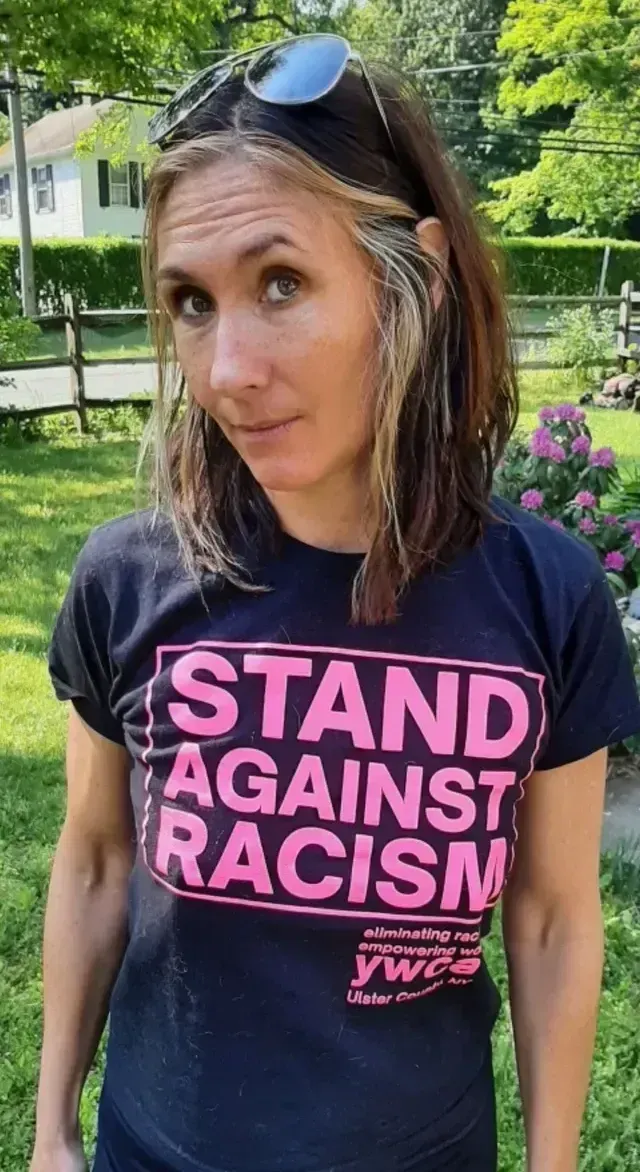 Woman wearing a black shirt that says 