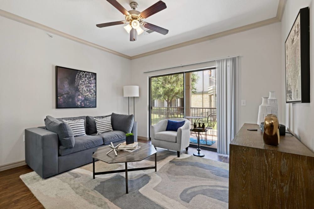 Living Room with Ceiling Fan and Balcony Access at The Marquis at Brushy Creek