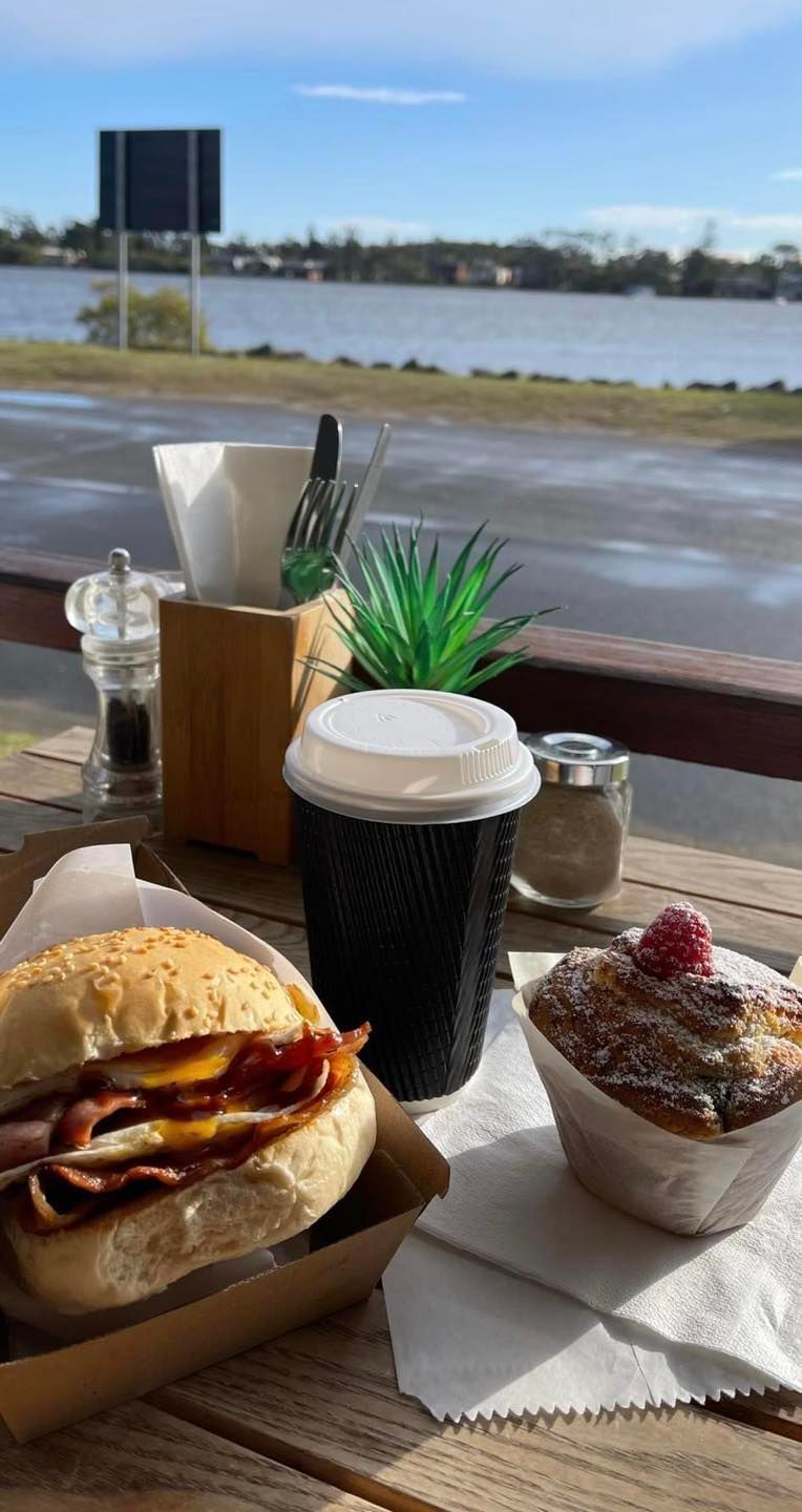 A Sandwich and A Cup of Coffee Are on A Wooden Table — The Point Cafe Restaurant in Port Macquarie, NSW